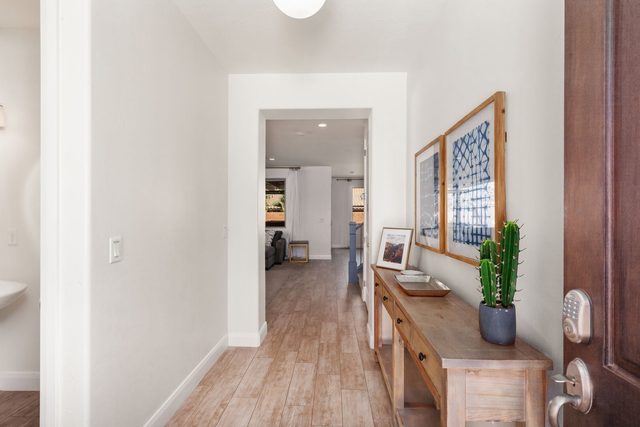 Front entry hallway with wood console table at Paradise Village 94