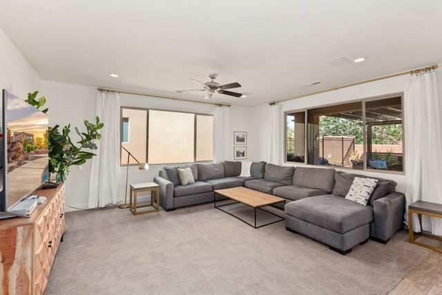 Main living room with gray sectional and smart TV at Paradise Village 94
