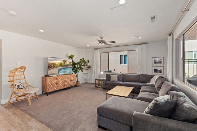Living room sectional with rattan chair and TV console