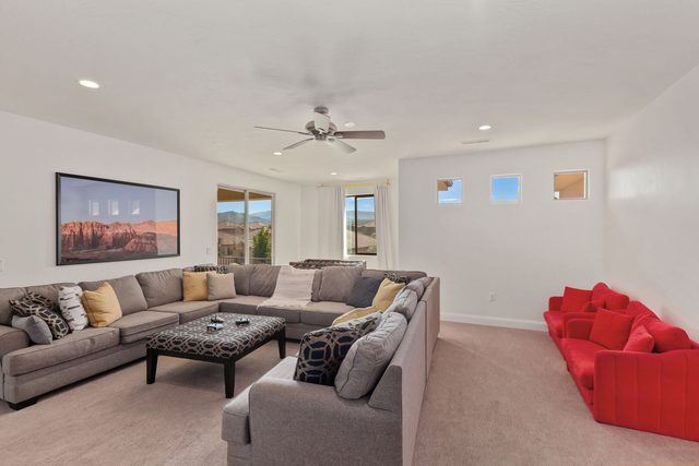 Upstairs living room with large sectional and red loveseat at Paradise Village 94
