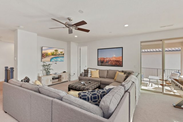 Second living room sectional with TV and balcony door
