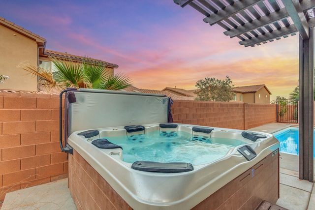 Private hot tub beside the pool at sunset