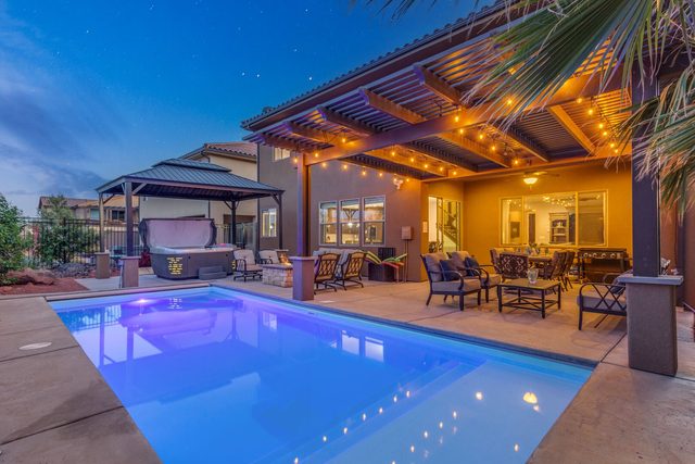 Private pool and lit covered patio at dusk at Paradise Village 96