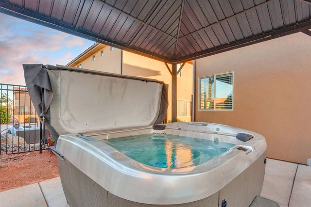 Private hot tub under metal gazebo in the backyard