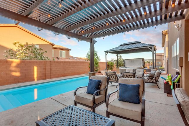 Private pool with pergola seating and gazebo hot tub