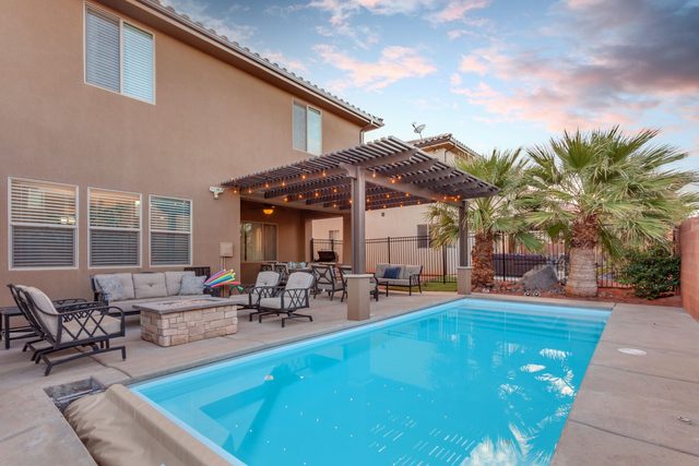 Private pool with covered patio and palm trees
