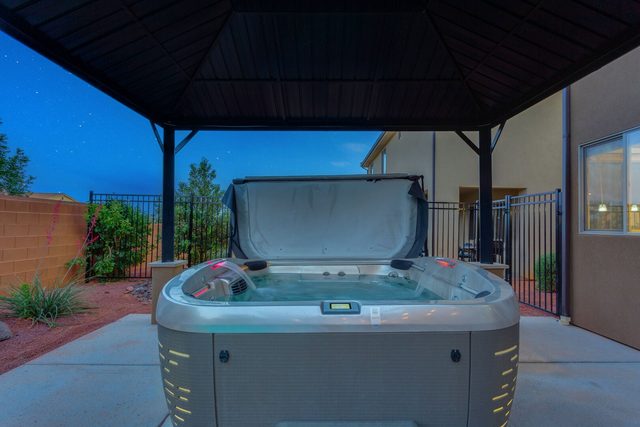 Private hot tub under gazebo at night