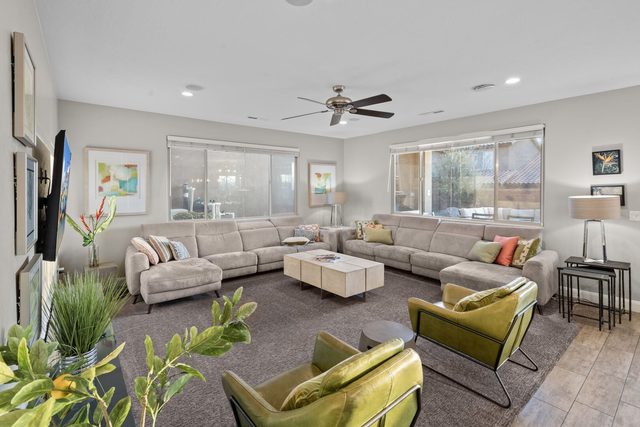 Living room with sectional sofas and lime accent chairs at Paradise Village 97
