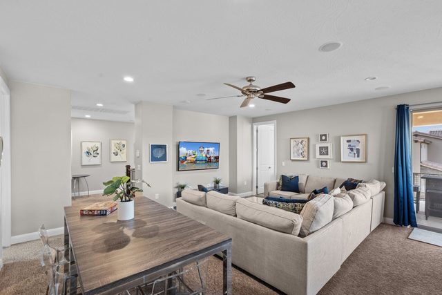 Second living room with dining table and wall TV