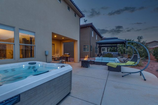 Private hot tub on back patio at dusk at Paradise Village 97