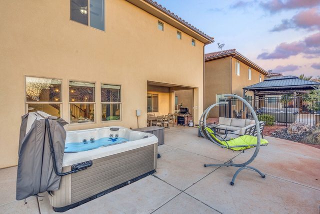 Private hot tub and hanging egg chair on patio at Paradise Village 97