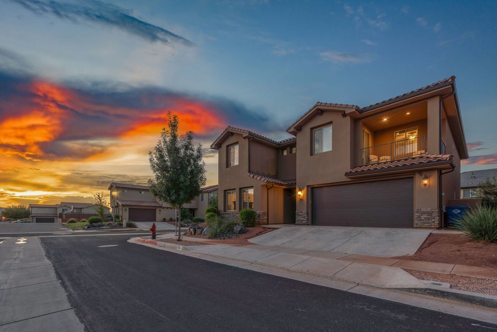 Two-story front exterior of Paradise Village 99 at sunset