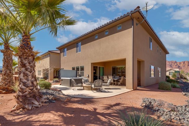 Rear exterior of Paradise Village 99 with palm trees and patio