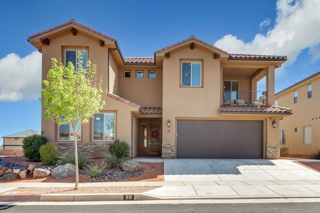 Front of Paradise Village 99 with two-car garage in daylight