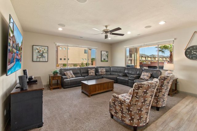 Living room leather sectional, armchairs and large smart TV