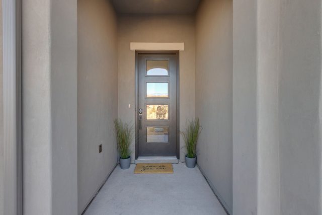 Front entry door with potted plants at Paseos 1101