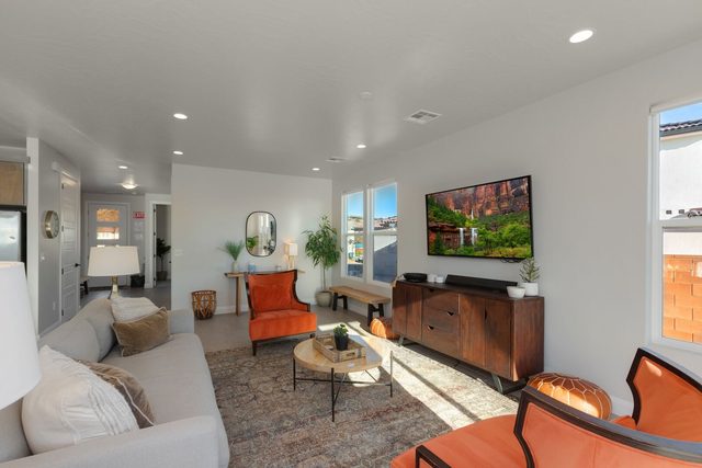 Living room with sofa, accent chairs and wall TV at Paseos 1101
