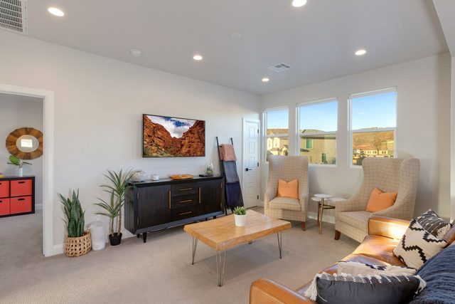 Upstairs loft lounge with sofa, armchairs and TV at Paseos 1101