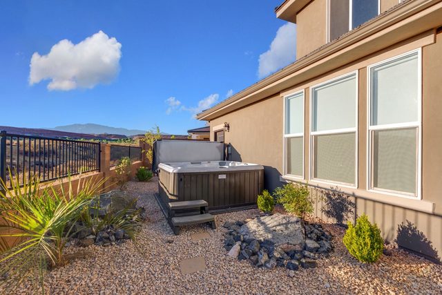 Private hot tub in the landscaped side yard at Paseos 1101