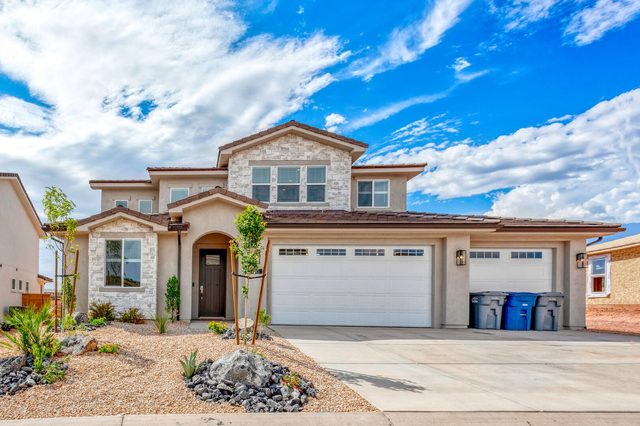 Two-story stone and stucco front of Paseos 1121 with three-car garage