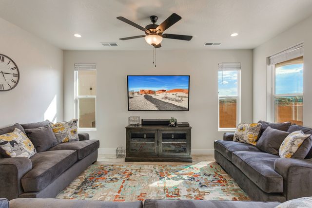 Living room seating around a TV console at Paseos 1121