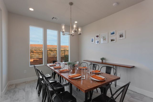 Dining table for ten with black metal chairs and chandelier