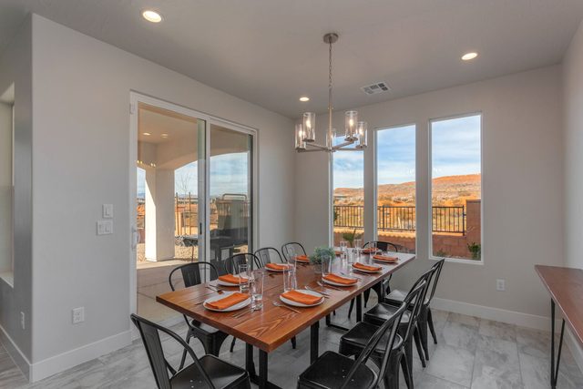 Dining area beside sliding patio doors with desert views
