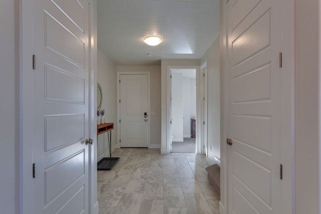 Tiled entry hallway leading to the front door