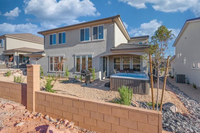 Back of Paseos 1141 with patio, grill and hot tub