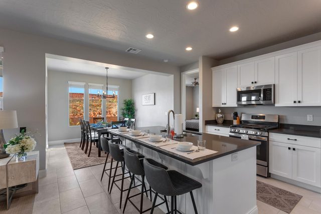 Kitchen island with bar stools leading to the dining area