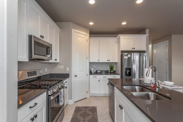 Gas range, microwave and stainless fridge in the kitchen
