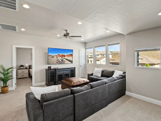 Upstairs loft with sectional sofa and large TV