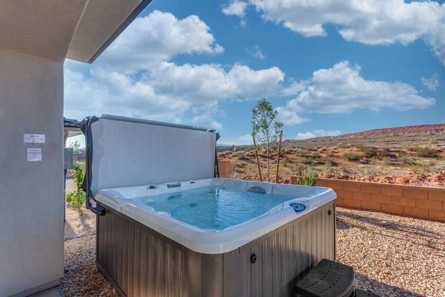 Private hot tub on the gravel backyard with desert views