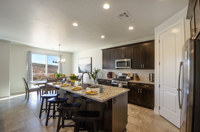 Kitchen island with bar stools and stainless appliances