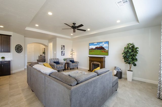 Living room with sectional sofa, fireplace and wall TV