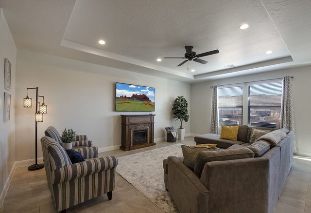 Great room sectional and armchairs facing the fireplace TV