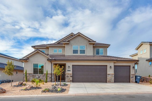 Front of Paseos 1149 with three-car garage and desert landscaping