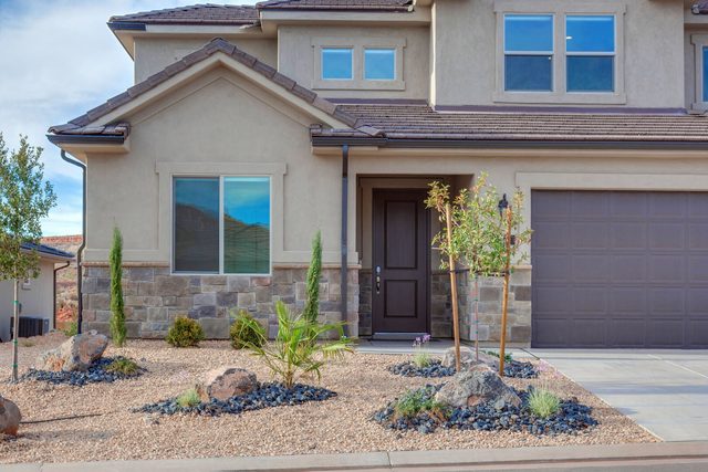 Front entry of Paseos 1149 with stone accents and landscaping