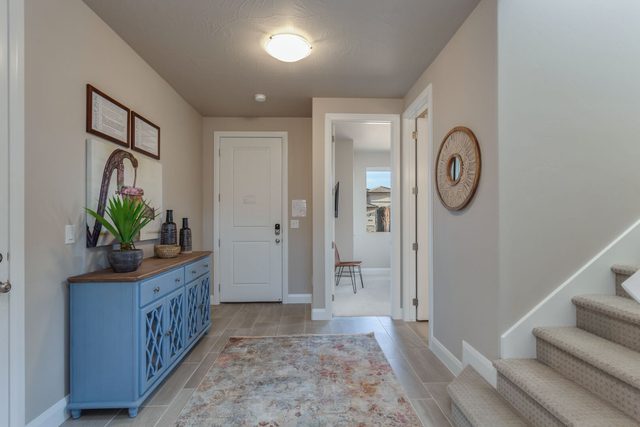 Entry hallway with blue console table and staircase