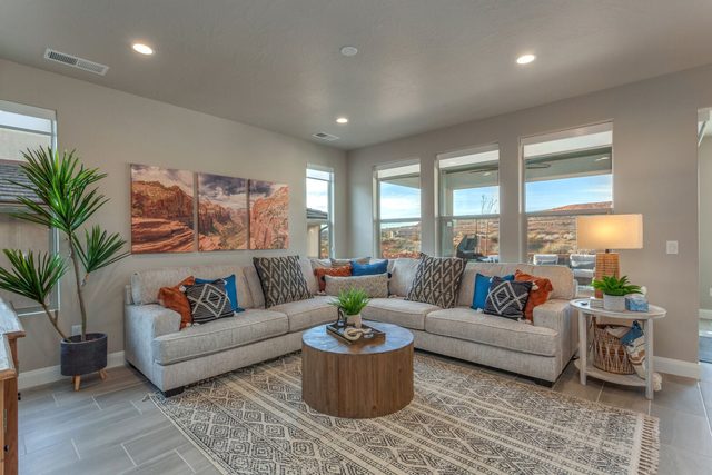 Living room sectional with round coffee table and red rock art