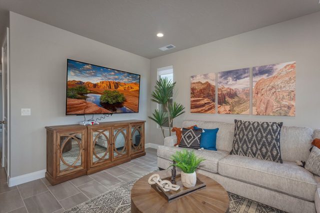 Living room with smart TV, sofa and wood media console
