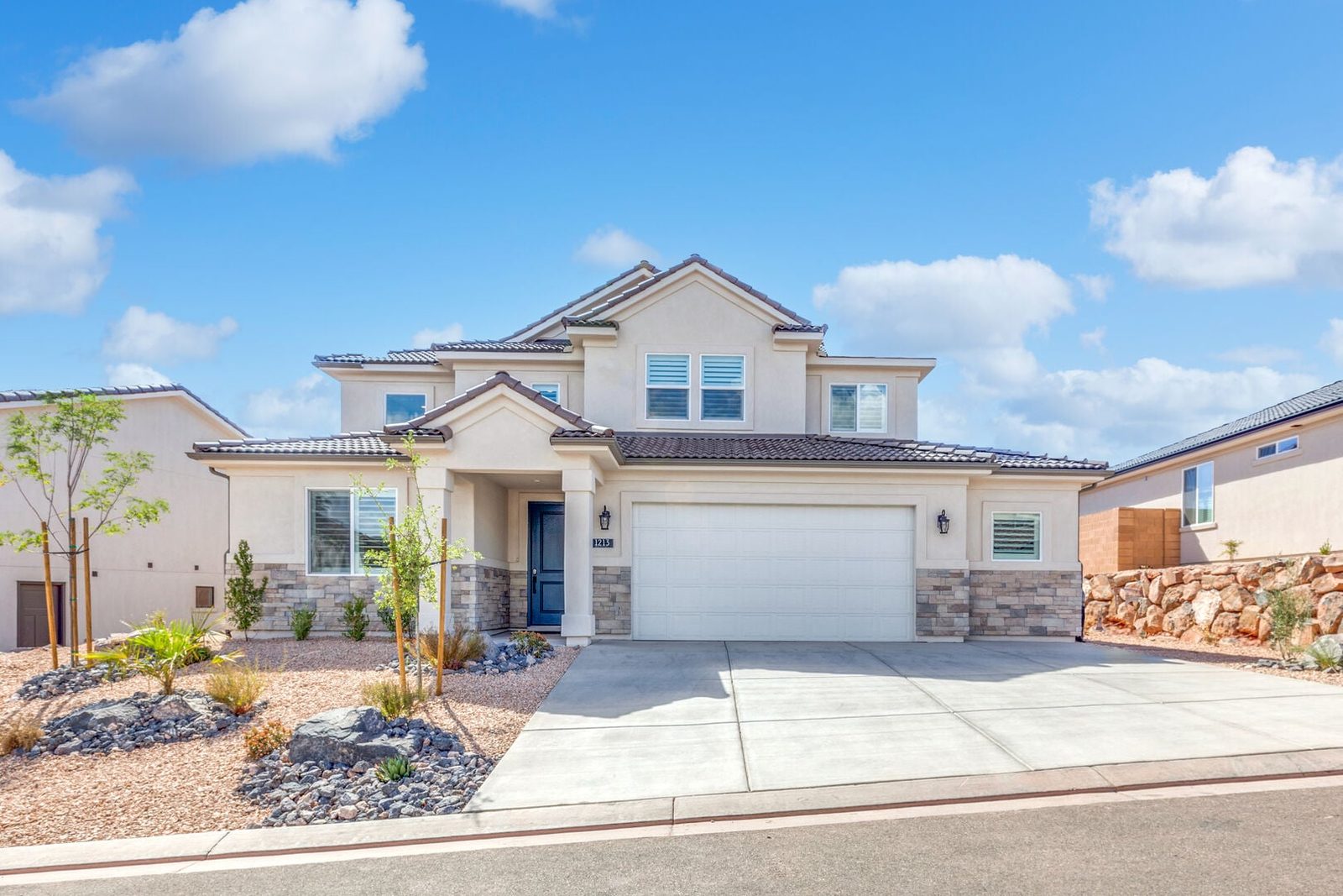 Front exterior of Paseos 1213~Bliss with two-car garage and driveway
