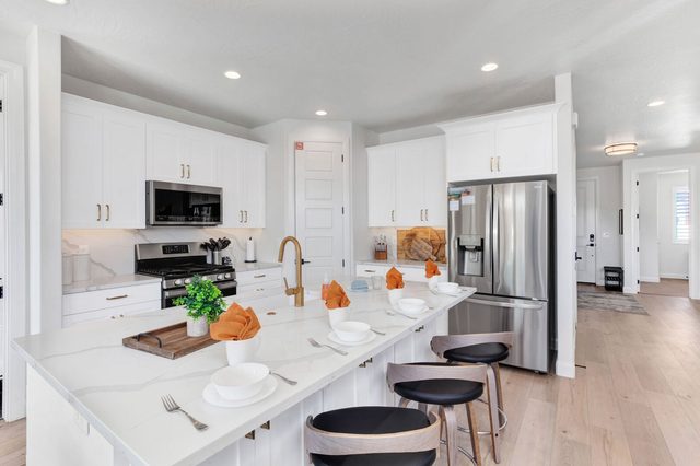 Kitchen island with bar stools and stainless steel appliances
