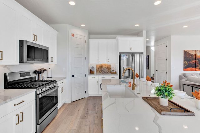 Kitchen gas range, microwave and farmhouse sink at Paseos 1213~Bliss