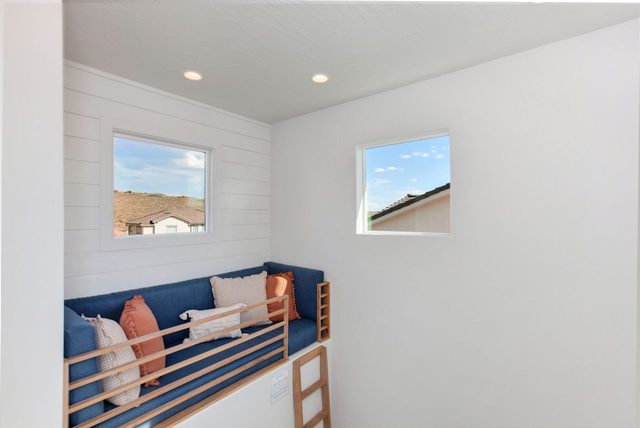 Reading nook with cushioned bench above the stairway