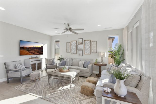 Main living room with two sofas, armchairs and wall TV