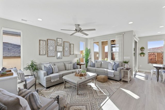 Living room seating area with patterned rug and patio door view