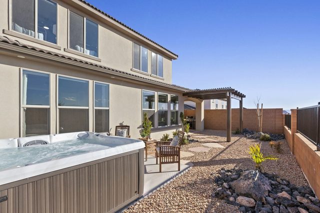 Private hot tub on the gravel backyard patio at Paseos 1249