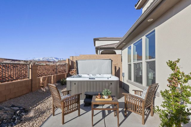 Private hot tub and patio chairs in the fenced side yard
