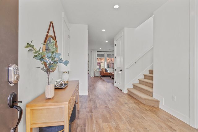 Front entry hallway with console table and staircase at Paseos 1308